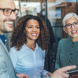 group of racially and gender diverse office workers smiling