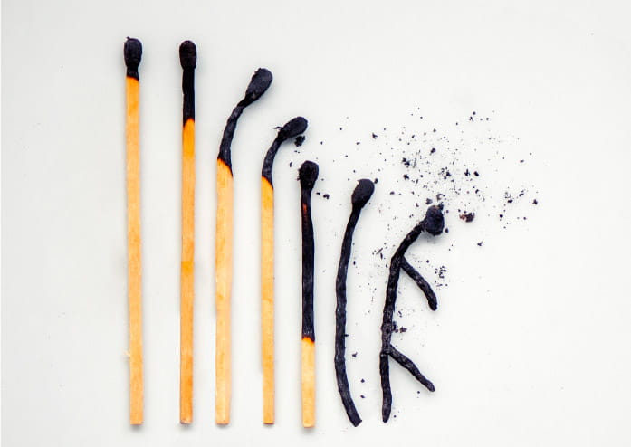 several matches lying in a row, each a little more burnt than the previous one